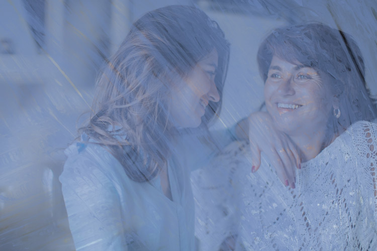 Younger & mature woman smiling at eachother